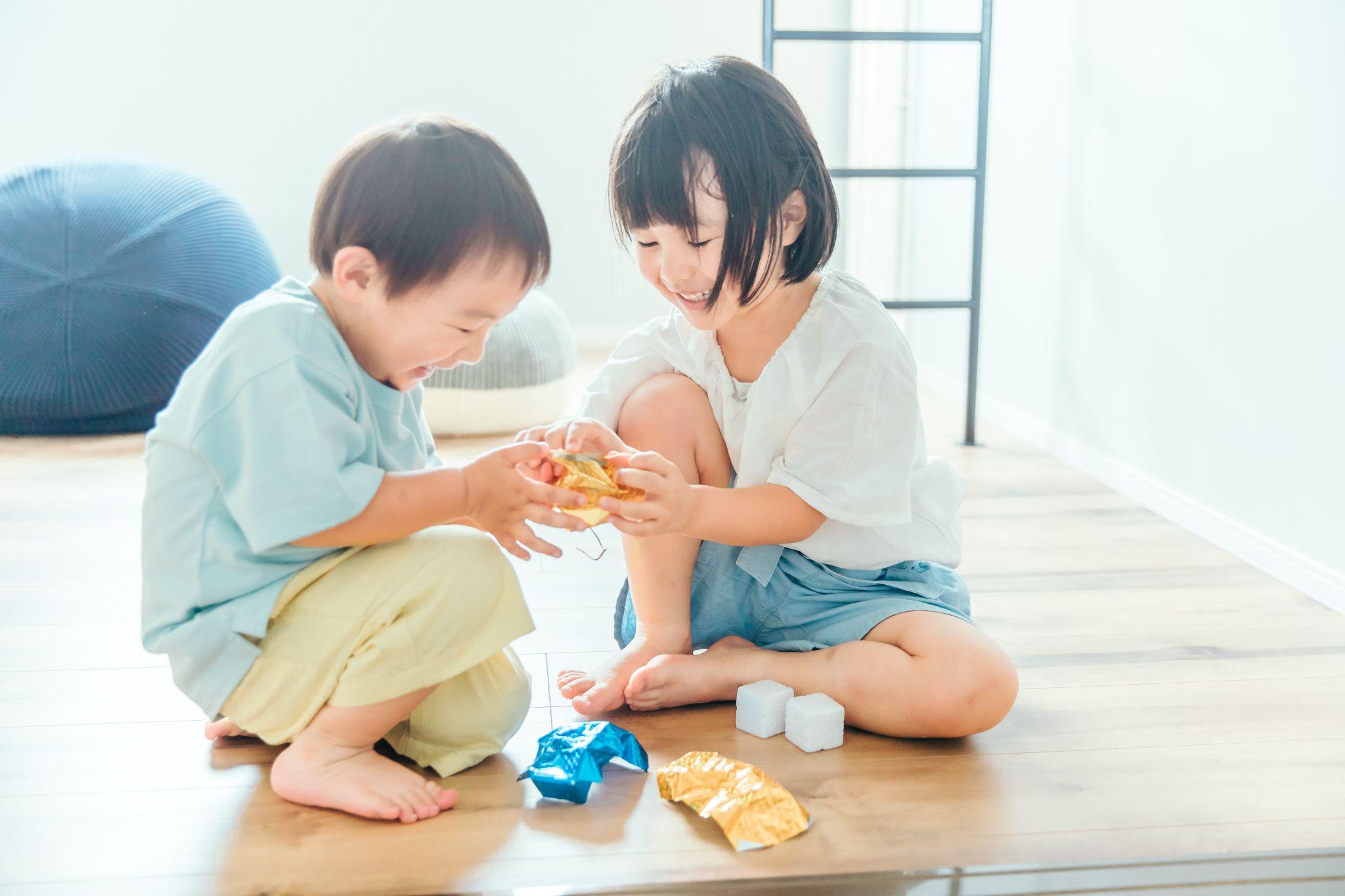 部屋で仲良く遊ぶ笑顔の兄妹